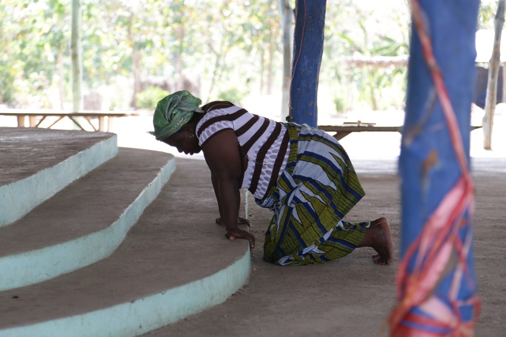 A woman kneels at a prayer centre a few miles away from Paul Noumonvi’s.